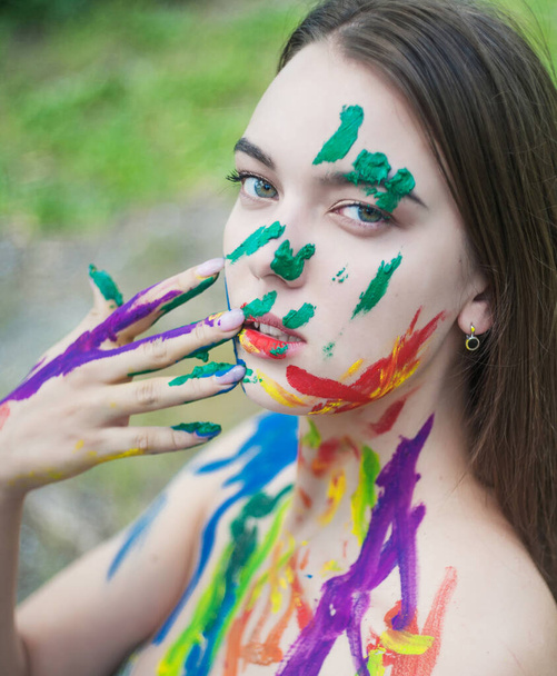 Close up portrait of young woman with paints on the face - Photo, Image