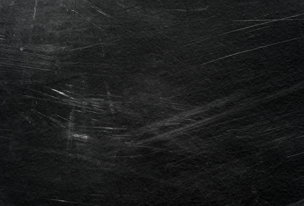 Old black stucco wall with white scratches and scuffs texture. textured grunge black board with chalk - Foto, Imagem