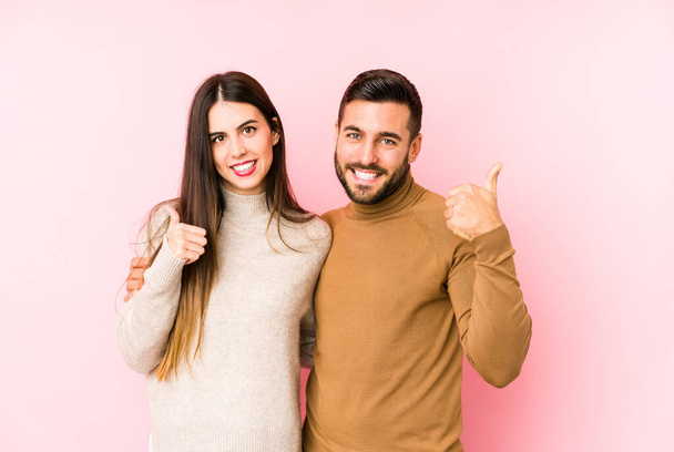 Young caucasian couple isolated raising both thumbs up, smiling and confident. - Foto, Imagem