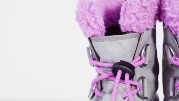 Little girl pink and gray warm and waterproof winter boots on a white background. - Footage, Video
