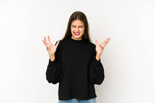 Young caucasian woman isolated on white background screaming with rage. - Fotografie, Obrázek