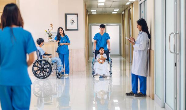 Group of professional medical doctor team with stethoscope in uniform working discussing and talk walking in hospital.health medical care concept - 写真・画像