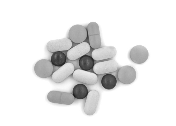 Black and white tablets (pills) on a white background - Photo, Image