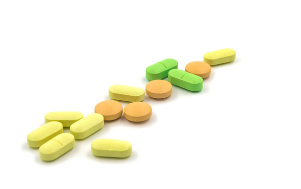 Multicolored tablets and pills on a white background - Photo, Image