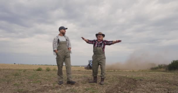 Gelukkige senior boer toont veld aan kleinzoon - Video