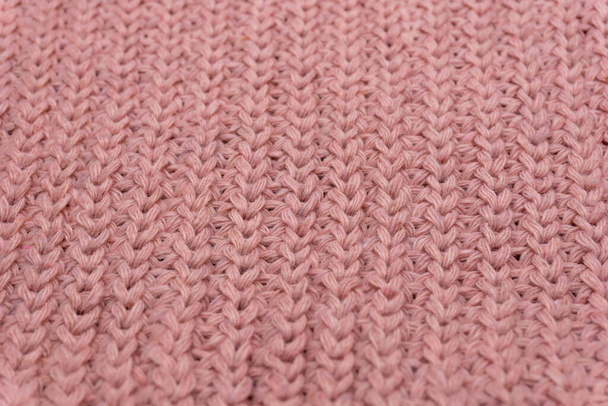 Rózsaszín kötött pulóver textúrája közelről, vörös kötött gyapjú - Fotó, kép