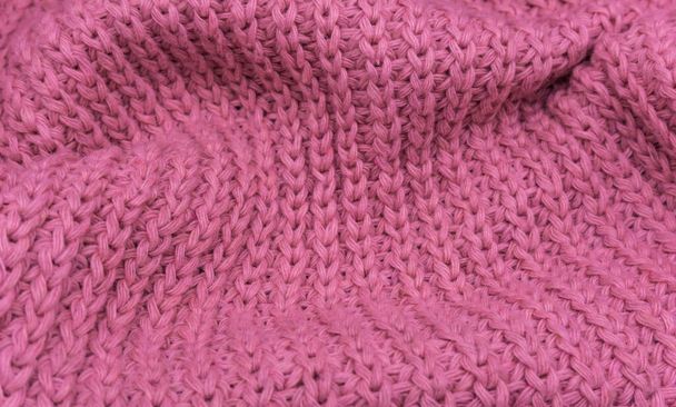 Rózsaszín kötött pulóver textúrája közelkép, vörös kötött gyapjú - Fotó, kép