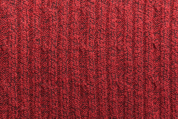 Textur eines roten Strickpullovers in Nahaufnahme. Gestricktes Wollmaterial - Foto, Bild