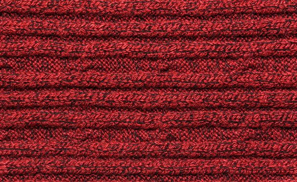 Egy piros kötött pulóver textúrája. kötött gyapjúanyag - Fotó, kép