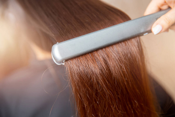 Concept straighten spa. Keratin recovery hair and protein treatment pile with professional ultrasonic iron tool - 写真・画像