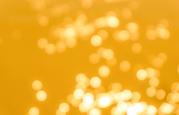 Yellow bokeh background texture. Golden blurred bright glare of light texture - Foto, Imagem