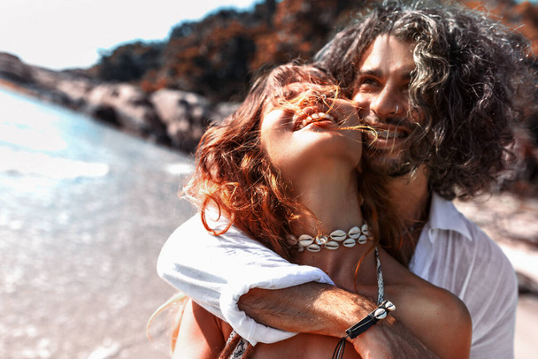 beautiful young cheerful couple having fun on the beach - Фото, зображення