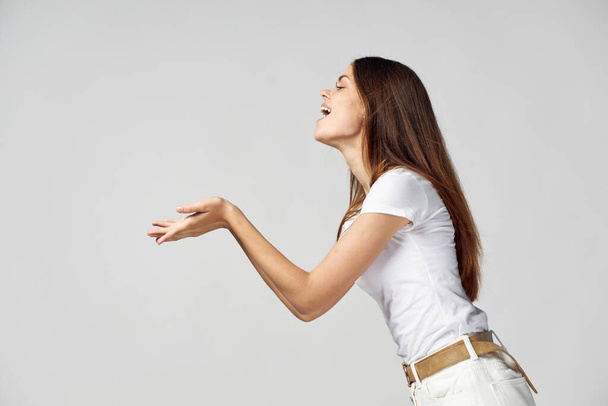 Woman holds open mouth in front of her emotions side view Copy Space - Photo, Image