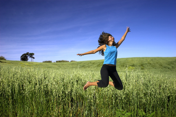 Jumping on a green field - Foto, Imagem