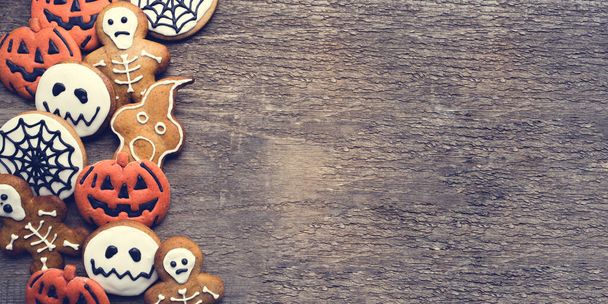 Halloween gingerbread cookies on wooden background. - Fotó, kép