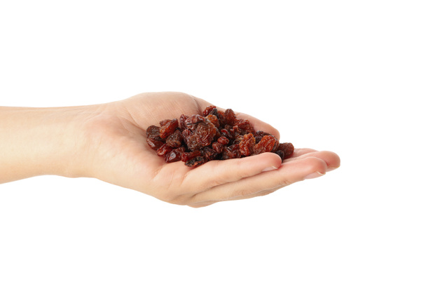 Female hand hold raisins, isolated on white background - Photo, Image
