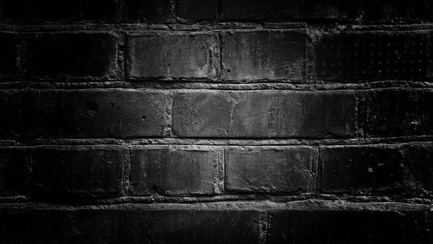 black brick wall with a light center for designers background texture - Foto, Imagen