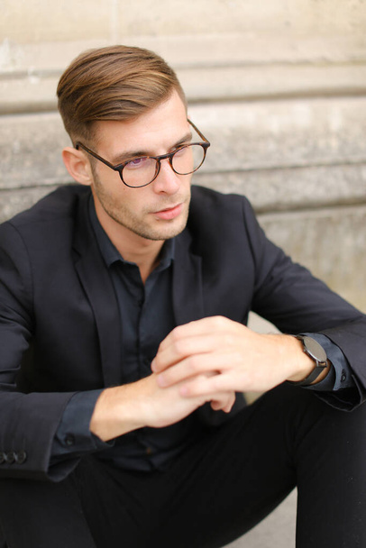 Portrait of businessman wearing black suit and glasses. - Fotoğraf, Görsel