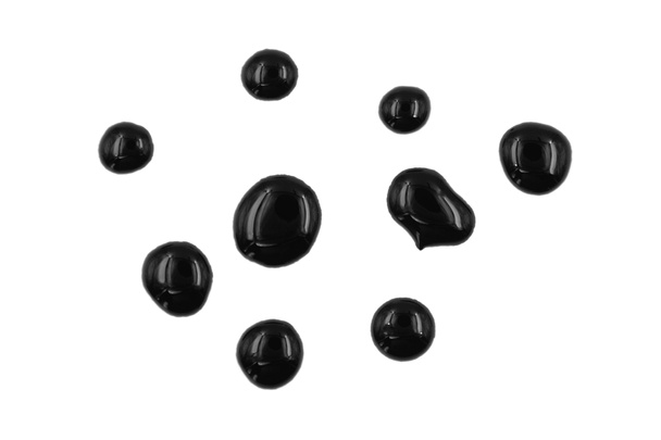 Goteando pintura negra aislada sobre fondo blanco. Salpicaduras de fuelóleo, gotas y rastro - Foto, Imagen