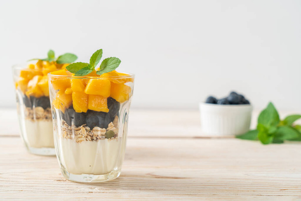 homemade fresh mango and fresh blueberry with yogurt and granola - healthy food style - Photo, Image