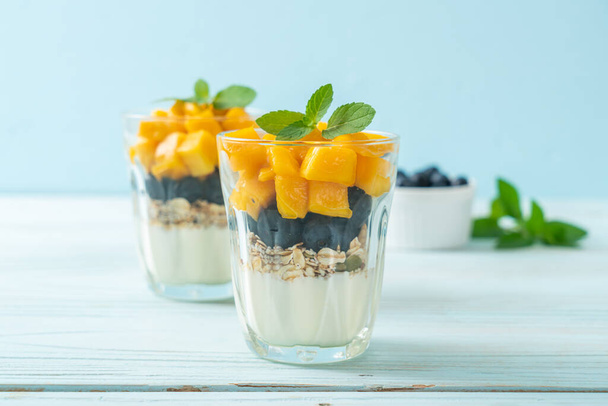 homemade fresh mango and fresh blueberry with yogurt and granola - healthy food style - Φωτογραφία, εικόνα