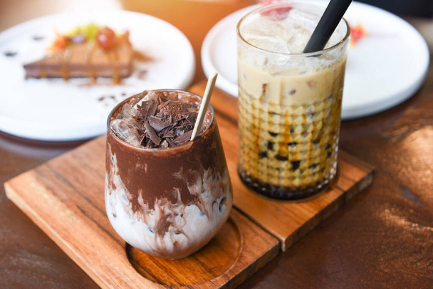 Cocoa drink chocolate and Bubble milk tea or Taiwan milk tea in glass on the wooden table with cake   - Photo, image