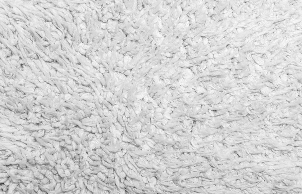 Witte wol textuur achtergrond, lichte natuurlijke schapenwol, textuur van witte pluizige vacht, fragment wol tapijt, grijze mat, wit tapijt - Foto, afbeelding