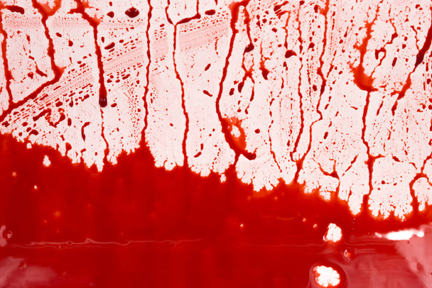 Bloody splashes and drops on a white background. Dripping and following red blood (paint) - Valokuva, kuva