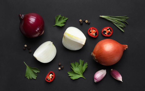 Flat lay composition with onion and spices on black background - Fotoğraf, Görsel