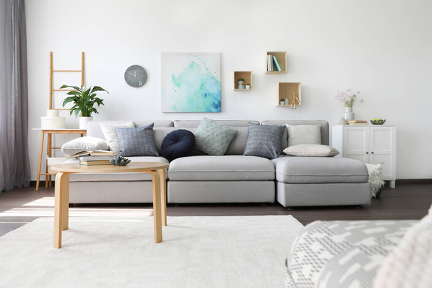 Elegant living room with comfortable sofa and wooden table. Interior design - Fotografia, imagem