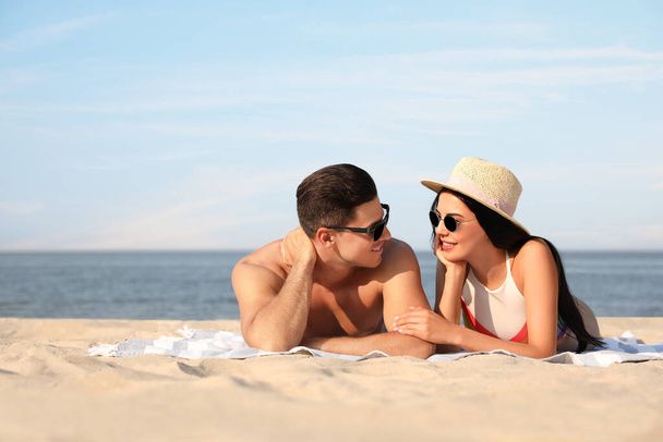 Happy couple resting on sunny beach. Space for text - Foto, immagini