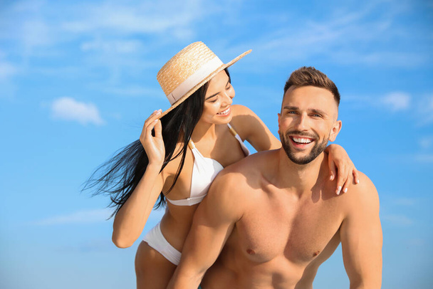 Happy young couple in beachwear on sunny day - Foto, immagini