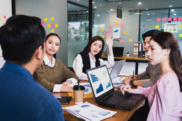 Focus on young beautiful asian woman having question in group brainstorm meeting in office.Businesspeople discussing with paperwork for business plan,Corporate of modern colleague - Photo, Image
