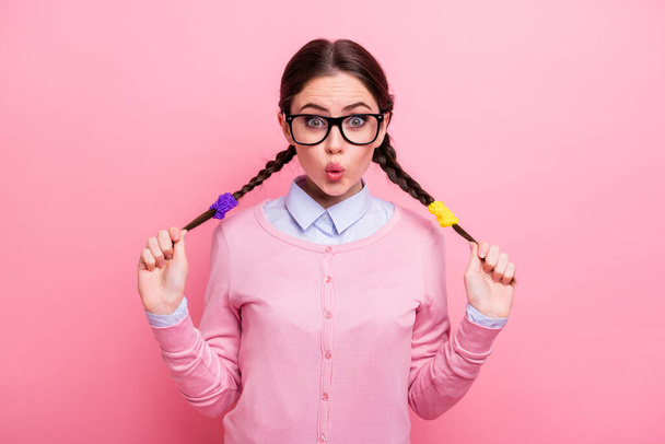 Close-up portrait of her she nice attractive pretty lovely positive funny amazed brown-haired teen girl having fun touching tails pout lips isolated pink pastel color background - Foto, imagen