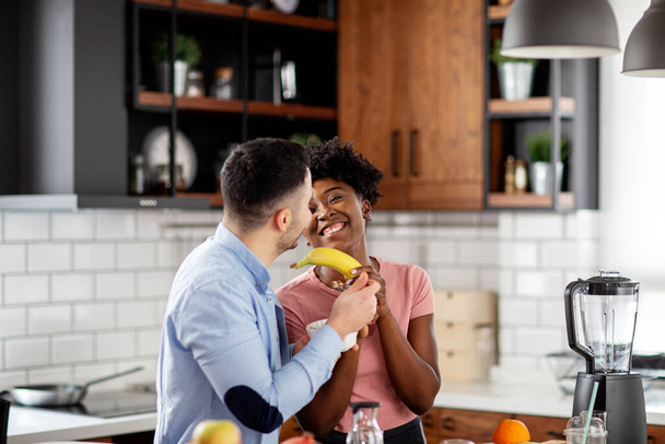 Couple in the kitchen smile and make juice - Zdjęcie, obraz