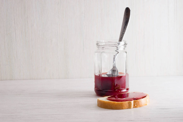 sandwiches with homemade strawberry jam and chocolate nut butter, cup of tea on a white wooden background - Foto, imagen