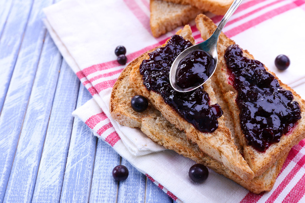 Delicious toast with jam on table close-up - Valokuva, kuva
