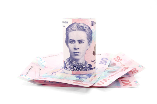 Украинские деньги 200 грн выделены на белом фоне. Банкнота свернута. Финансовая концепция. - Фото, изображение