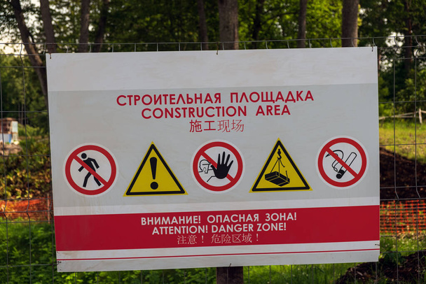 Russia, Vyborg, Leningrad region June 2020: sign on the construction site warning of danger, inscription in Russian, English and Chinese - Fotoğraf, Görsel
