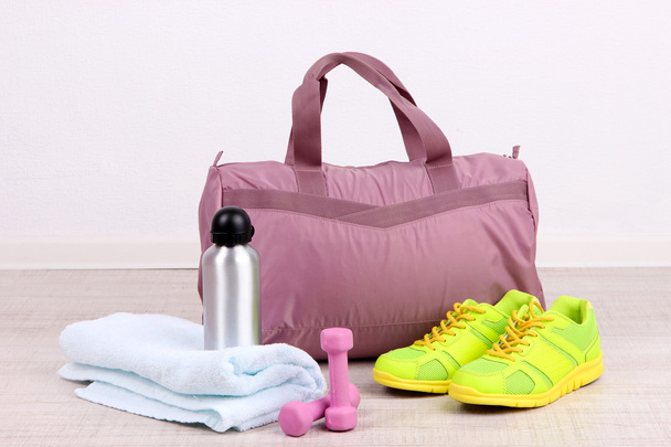 Sports bag with sports equipment in gymnasium - Fotó, kép