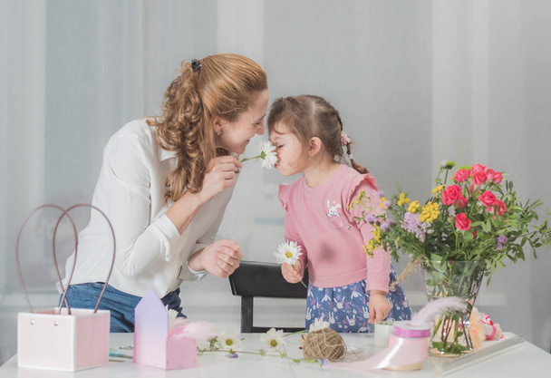happy mom and daughter make bouquets for the holiday. Family business of flowers. Mother and daughter. Flower shop "Lifestyle". - Fotografie, Obrázek