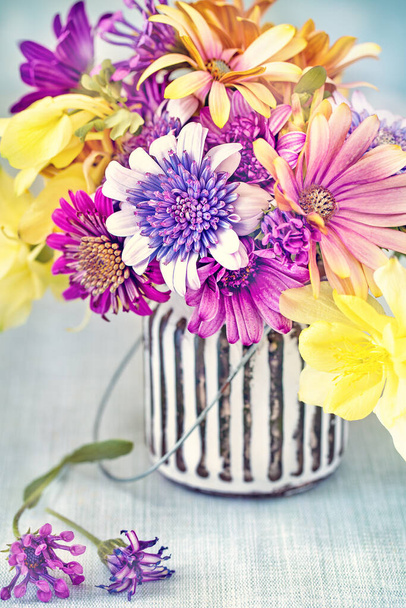 Beautiful bouquet of spring flowers in a vase on the table. Lovely bunch of flowers. Beautiful fresh flowers on a table. - Φωτογραφία, εικόνα