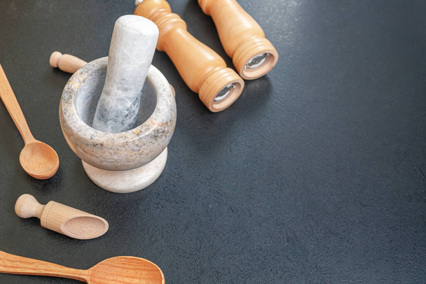 stone mortar and wooden spoon for light on the table, copies of space - Foto, Bild