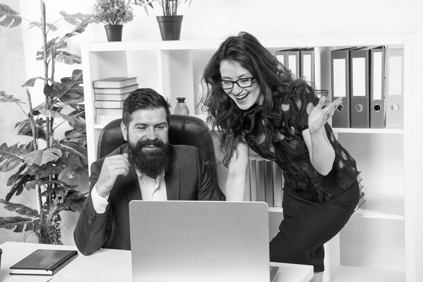 Interacting with partners online. Happy couple work online. Bearded man and sexy woman use computer. Online marketing. E-trading. E-commerce. Running business online. New technology. Video call - Фото, изображение