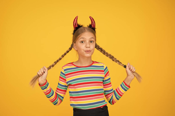 Little demon inside. Girlish temper. Cute but dangerous. Halloween concept. Small adorable child with red horns. Accessories for carnival. Preparing for party. Small demon. Playful demon girl - Фото, изображение