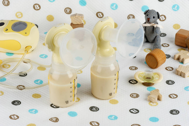 double Breast pump with milk in baby bottle - Photo, Image