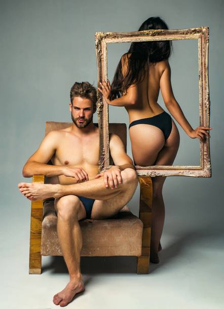 Attractive young couple holding picture frame. Attractive man and woman being playful. Erotic and spiritual feeling. Copy space. Young man and woman. Intimate relationship and sexual relations. - Fotografie, Obrázek