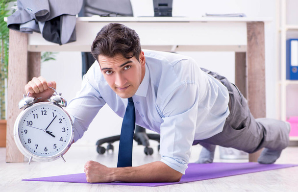 Businessman doing sports in office during break - Photo, Image