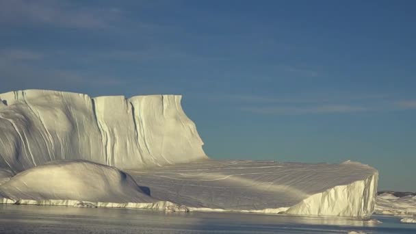 Ανταρκτική. Όμορφο μπλε παγόβουνο με αντανάκλαση καθρέφτη επιπλέει σε ανοιχτό ωκεανό. Ηλιοβασίλεμα στο βάθος. Μαγευτικό χειμερινό τοπίο. Ταξίδι - Πλάνα, βίντεο