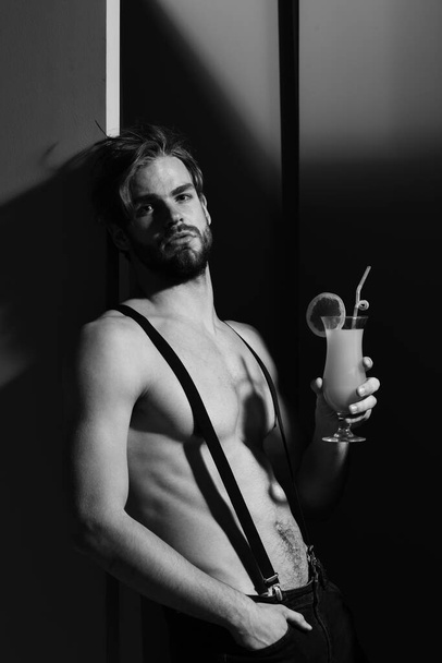 handsome muscular man with cocktail - 写真・画像
